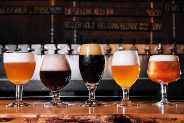 glasses of different beers on a bar